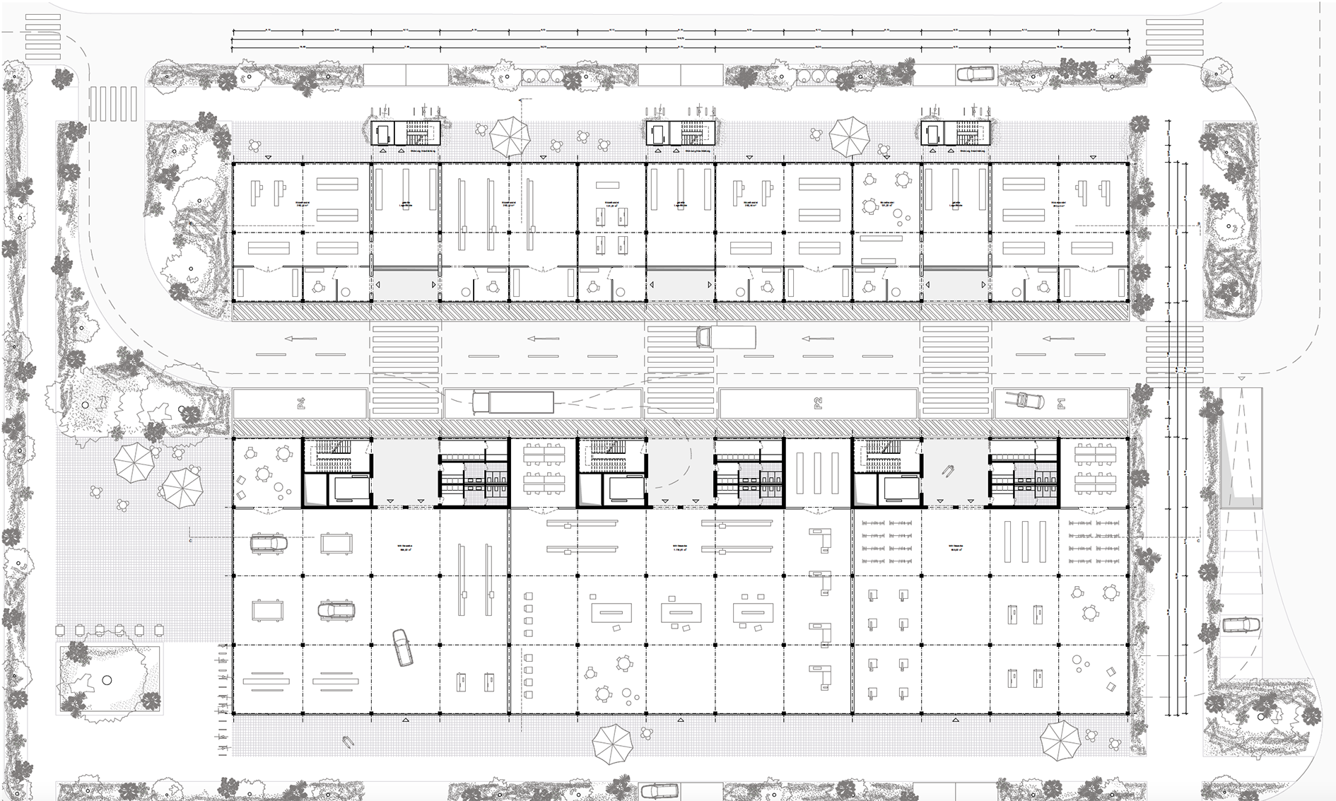 Der Grundriss zeigt einen in zwei Teile gegliederten rechteckigen Baukörper, der asymmetrisch durch eine Straße getrennt wird. Die Straße wird von LKWs, Transportern und einem Gabelstapler genutzt. Es ist zu erkennen, dass beide Gebäudeteile von dieser Straße – der Werkstraße – erschlossen werden und sich in eine Vielzahl an kleineren und größeren Gewerbeeinheiten unterteilen lässt. Um das Gebäude sind Grün und Sonnenschirme zu erkennen. Im Norden gibt es außerdem drei Treppentürme, welche die oberen Wohngeschosse erschließen.